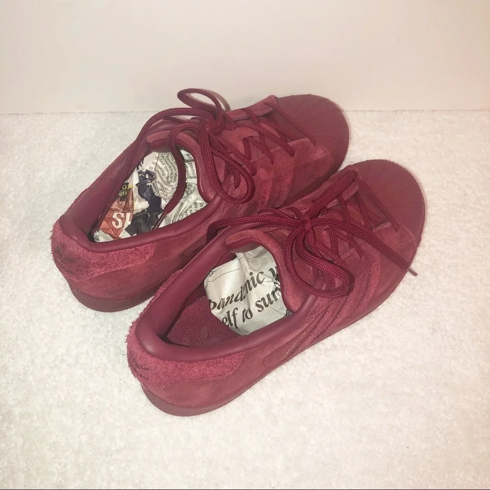 Adidas superstar suede burgundy shell toe sneaker.